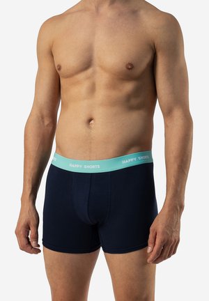 Donkerblauwe boxer shorts met een lichtblauwe tailleband gemarkeerd "HAPPY SHORTS." De stof lijkt glad en heeft een strakke pasvorm.
