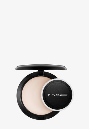 Ronde zwarte compact met lichtgewicht beige poeder. Inclusief een aparte zwarte poederapplicator met een witte rand. Soepele, matte afwerking.