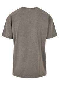 Gray cotton t-shirt with a relaxed fit, short sleeves, a crew neckline, and a faded, textured finish. Machine-stitched hems.