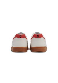 White sneakers with red accents and black detailing on the heel. Rubber sole, smooth texture, and classic low-top design.