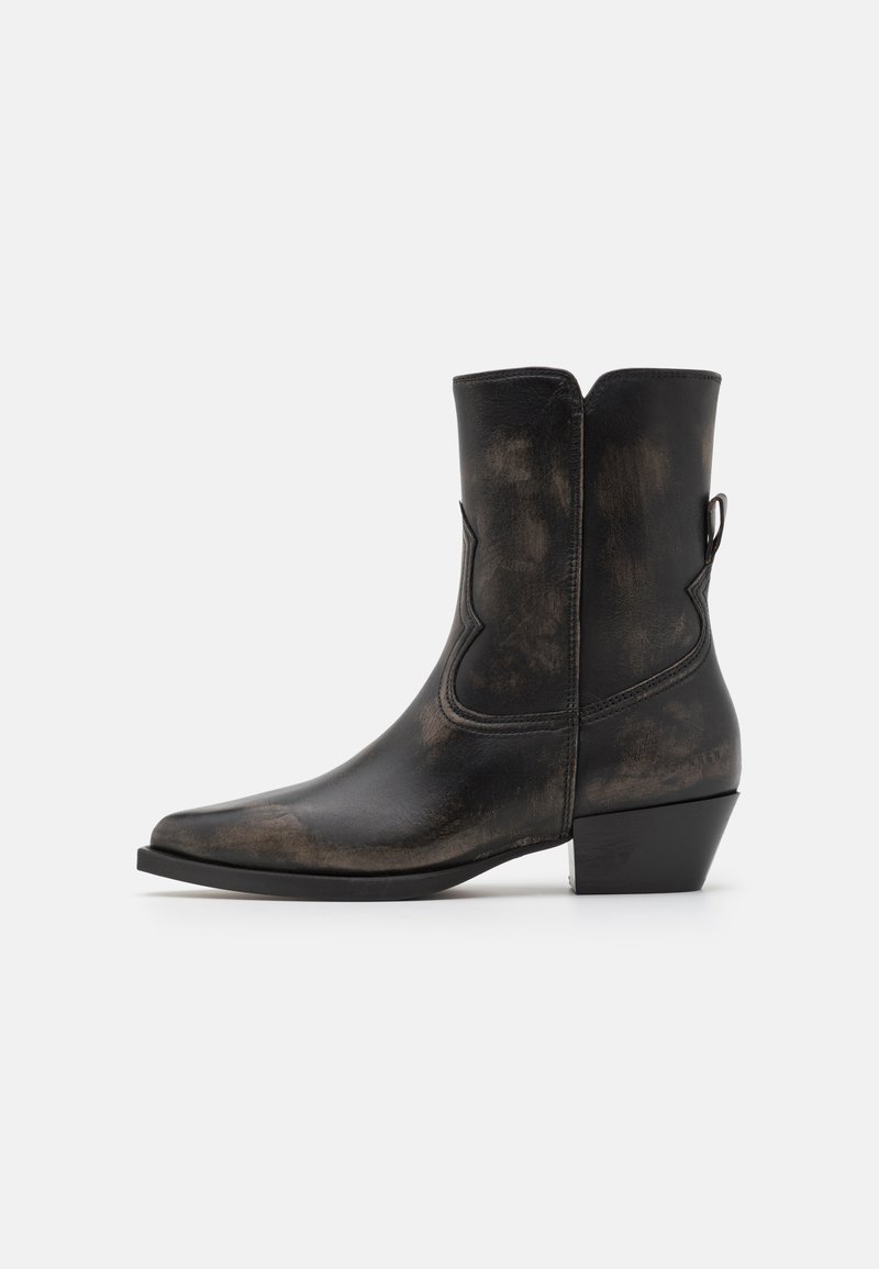 Black leather cowboy boot with a pointed toe, Western stitching detail, and stacked heel. Textured finish with a distressed look.