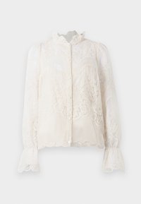 Blusa de encaje en color blanco roto, con cuello con volantes, cierre de botones en la parte delantera y mangas acampanadas. Patrones florales delicados en tela semitransparente.