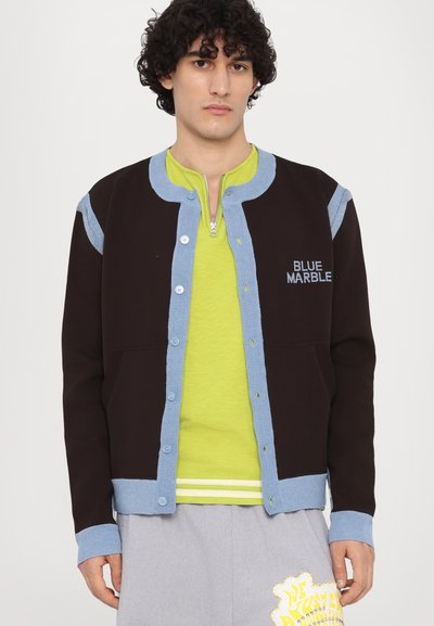 Black and blue fleece jacket with button closure and ribbed cuffs, featuring "BLUE MARBLE" embroidered on the chest. Underneath is a lime green shirt.