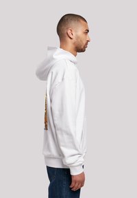 Sudadera blanca con un bolsillo canguro y una gran impresión gráfica en la parte posterior. Cuenta con una capucha con cordón ajustable y puños y dobladillo de canalé.