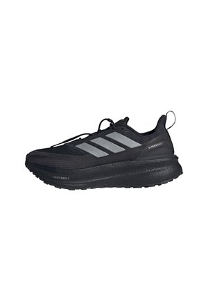 Black athletic shoes with a textured mesh upper, three silver stripes, and a thick black rubber outsole labeled "Light Boost" and "Ultraboost."