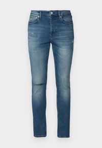 Jeans din denim albastru cu o croială slim, având ușoare uzuri și o tăietură la genunchi. Design clasic cu cinci buzunare și închidere cu buton metalic.