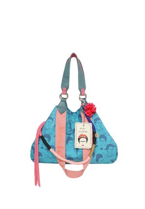 Blue and pink bag with a textured finish, featuring Frida Kahlo prints, a decorative flower, tag, and braided strap accents.