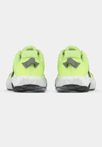 Neon green athletic shoes with a textured mesh upper, gray accents, speckled white midsole, and black rubber outsole.