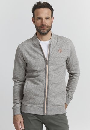 Gray zip-up sweatshirt with a textured finish, ribbed cuffs and hem, and a small logo on the left chest. Features a contrasting zipper.