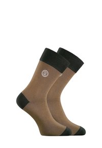 Chaussettes marron en mélange de coton avec un revers côtelé vert foncé. Présentent un logo sur le côté et un renfort au niveau des orteils et du talon pour plus de durabilité.