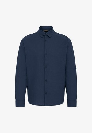 Mørkeblå skjorte med lange ermer, knapp-ned krage, frontknapper og opprullede ermer. Laget av et strukturert stoff.