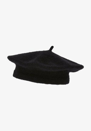 Schwarze Wollmütze mit runder, flacher Form und einer kleinen Schlaufe oben. Weiche Textur mit leicht flauschigem Finish. Einheitliche Farbe über das gesamte Stück.