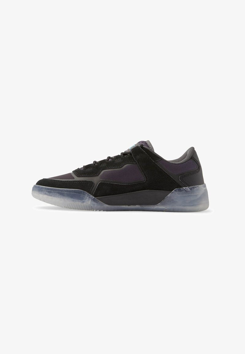 Black sneaker with a mix of suede and mesh materials, featuring a clear rubber sole, geometric design, and subtle purple accents.