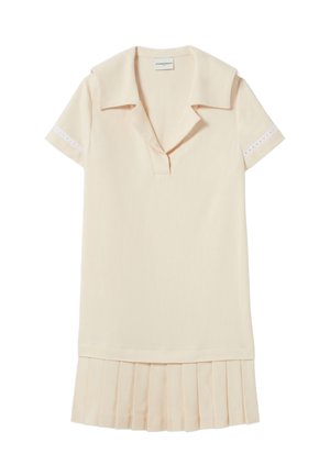Robe beige pâle avec un col, des manches courtes et des détails en œillets aux poignets. Dotée d'un ourlet plissé. Texture de tissu lisse.