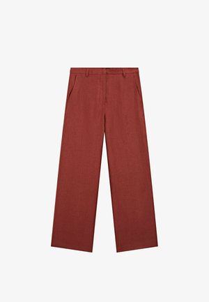 Wide-leg trousers in rust-colored fabric, featuring side pockets and a seamless front, made of a textured, lightweight material.