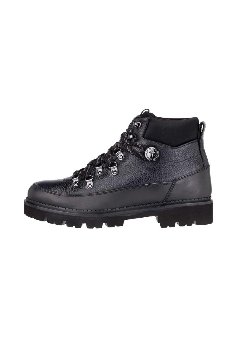 Bota de senderismo negra con parte superior de cuero texturizado, puntera reforzada, siete ojetes metálicos y suela de goma rugosa para tracción.