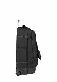 Rolkoffer van stofmateriaal, oversized ontwerp, soepele wielen, uittrekbare handgreep en zijvak voor accessoires.