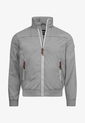 Grå vindjakke med høj krave, frontlynlås og to sidelommer med lynlås. Har ribbede manchetter og kant med læderdetaljer.