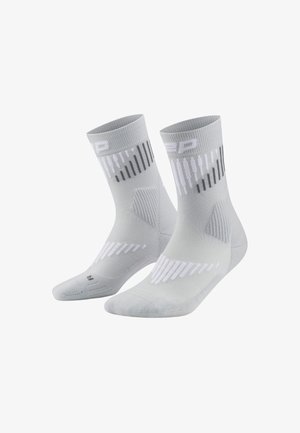 Light grey athletic socks with ribbed texture, white and black accents, and dynamic stripe patterns on the upper part.