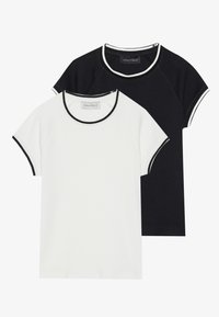 Set of two t-shirts: one white and one black, both with short raglan sleeves and contrasting necklines. Soft cotton fabric, casual fit.