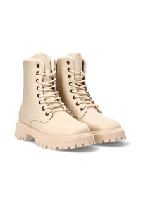 Botas de tobillo de encaje color beis, fabricadas con material sintético, que cuentan con una suela de goma resistente con un borde texturizado y una cremallera en el lateral.