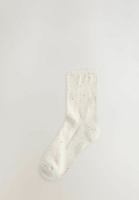 Kniestrümpfe aus weißen Material mit bunten Sprenkeln, geripptem Bündchen und weicher Textur. Abgerundete Zehenpartie und nahtloses Design für höchsten Komfort.