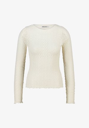 Chemise à manches longues de couleur ivoire clair, présentant un motif texturé, un col rond et un ourlet festonné. Confectionnée dans un matériau léger et extensible.