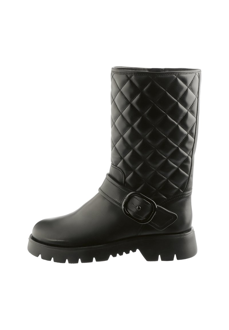 Black mid-calf boot with quilted upper, thick lug sole, rounded toe, and decorative strap with a large buckle on the side.
