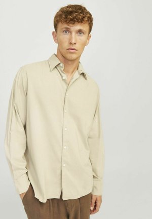 Beige long-sleeve shirt with a relaxed fit, button-up front, and a small collar. Fabric appears soft with minimal texture.