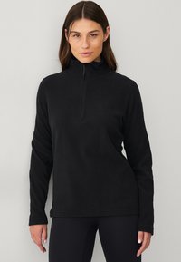 Zwarte fleece pullover met een hoge kraag en een halve rits. Heeft lange mouwen en een ontspannen pasvorm. Zachte textuur en een minimalistisch ontwerp.
