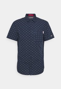 Košile s krátkým rukávem v námořnicky modré barvě s vzorem malých kontrastních tvarů. Má náprsní kapsu a značkovou štítek na rukávu.