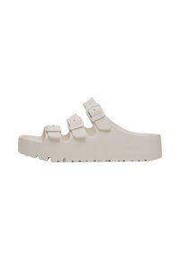 Sandali beige chiaro in gomma con tre fibbie regolabili e una suola testurizzata per una buona aderenza. Design sagomato con punta aperta.