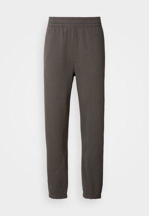Donkergrijze sweatpants met een elastische tailleband, taps toelopende pijpen en ribgebreide manchetten. Voorzien van een klein logo op de dij. Gemaakt van zachte stof.