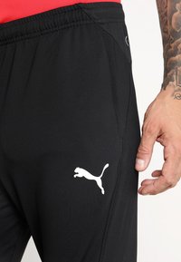Puma LIGA TRAINING PANTS PRO - Pantalon de survêtement - black/white