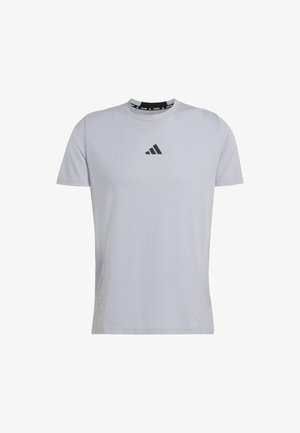 Light gray short-sleeve T-shirt made of soft fabric. Features a black Adidas logo on the chest and a rounded neckline with contrasting band.