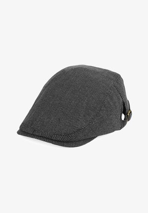 Gorra de espiga gris hecha de tela texturizada, con visera curva y un botón decorativo en el lado. Forma y diseño clásicos.