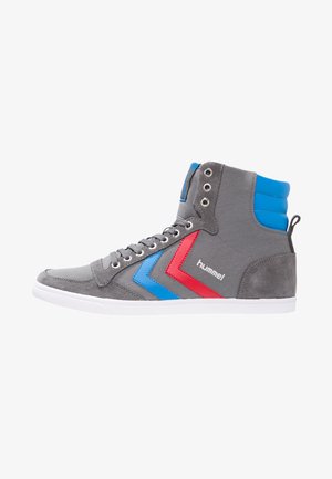 High-top sneakers in gray suede with blue and red chevron accents, white rubber sole, and metal eyelets for laces.