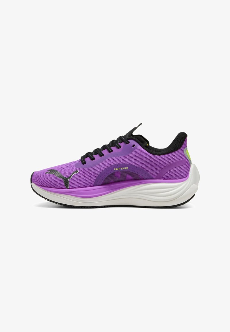 Purple running shoe with a textured mesh upper, black laces, and white midsole. Features a distinctive logo and minimalist design accents.