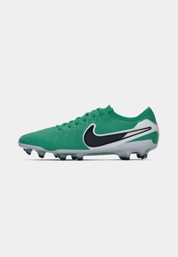 Green soccer cleat with textured upper, black Nike logo, white accents, and molded studs for traction. Lightweight design suitable for play.
