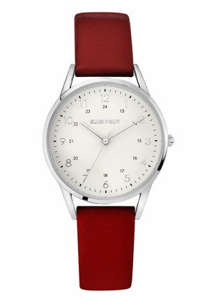 Round silver analog watch with white dial, black hour markers, red leather strap, and brand name "SURI FREY" at center.