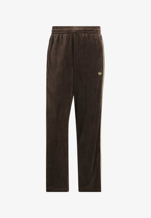 Brown velour track pants with elastic waistband, side stripes, and small Adidas trefoil logo on the left thigh.
