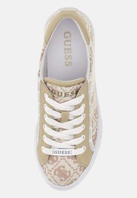 Sneaker in tela beige con un design a motivo, lacci bianchi, suola spessa e branding "GUESS" sulla linguetta e sul lato. Texture liscia.