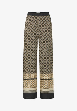 Široké nohavice v čiernej farbe s geometrickým zlatým a krémovým vzorom. Elastický pás s kontrastnou textúrovanou látkou na spodku a na leme.
