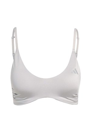 Brassière de sport gris clair avec fines bretelles réglables, encolure arrondie et design sans coutures. Présente un logo de marque subtil dans le coin supérieur.