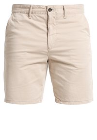 Beżowe szorty bawełniane o gładkim przodzie, z zapięciem na guzik, szlufkami na pasek i kieszeniami bocznymi. Gładka tekstura, luźny krój i długość do kolan.