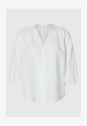Hvid bluse med lange ærmer, knaplukning foran, rynket halsudskæring og elastiske manchetter, vist på en neutral baggrund.