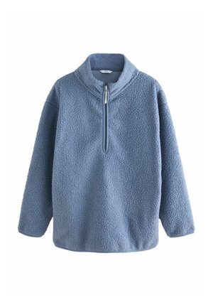 Pull en polaire bleu clair avec un col montant, fermeture éclair demi-longueur et surface texturée. Il présente des manches longues et une coupe décontractée.