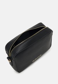 Black leather crossbody bag with a textured finish, featuring gold zippers and a logo. Designed with a rectangular shape and top opening.