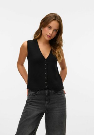 Zwarte mouwloze top met een V-hals, voorzien van een knoopsluiting aan de voorkant en een licht gebogen zoom. G gedragen met donkergrijze wijde jeans.