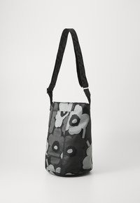 Black and gray floral-patterned handbag with a semi-structured design and adjustable strap. Smooth textile material with contrasting accents.